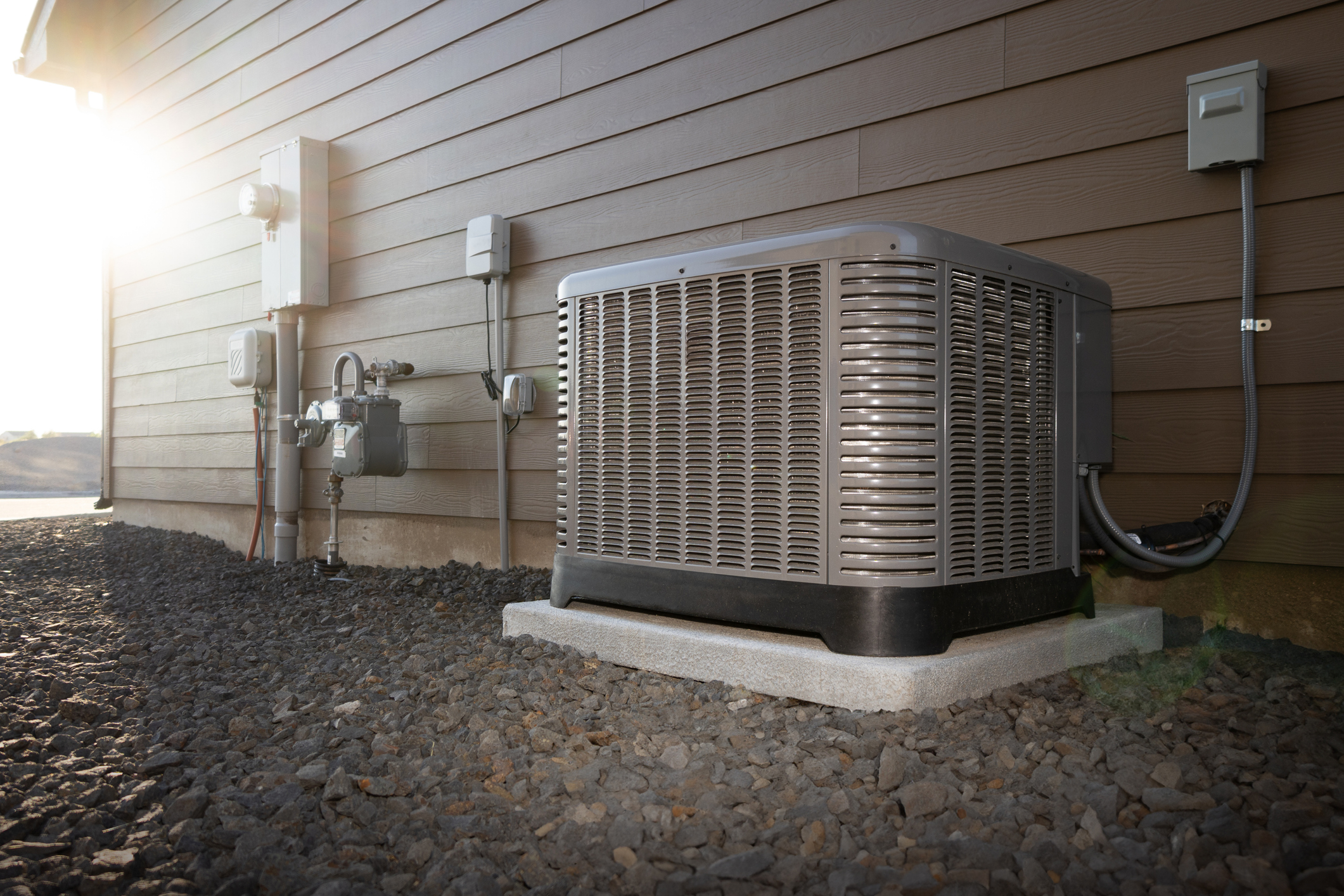 Professional HVAC technician servicing an air conditioning unit